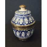A blue and white Islamic style jar and cover.