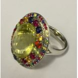 An 18ct white gold dress ring set with a large central stone (possibly citrine) surrounded by