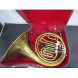A brass KMI, Lewington, London French horn in case