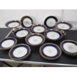 A Limoges blue and gilded part dessert service with two tazzas, four cake plates and ten plates