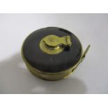 A vintage brass tape measure 'Universal'