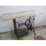 A cast iron Singer treadle base with wooden top