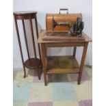 An Edwardian inlaid plant stand along with a Singer sewing machine and oak occasional table