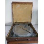 A wedding cake stand and knife in wooden box