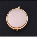 An unmarked gold locket set with agates.