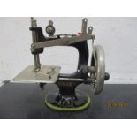 A miniature child's Singer sewing machine, approx 16cm height