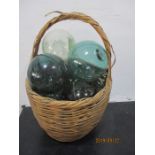 A basket containing various glass fishing floats