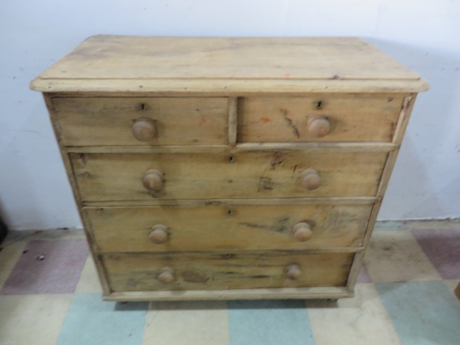 An antique pine chest of drawers