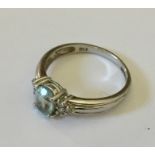 A 9ct white gold diamond and aquamarine ring.