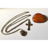 A silver cross on chain, silver heart shaped locket along with an agate brooch.