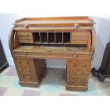 A Victorian oak cylinder kneehole desk