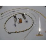 Three 925 silver necklaces along with one other, amber silver pendant and a pair of earrings.