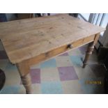 A pine farmhouse table with single drawer