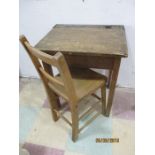 A vintage child's school desk and chair