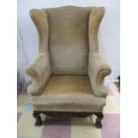 A Georgian style wing back armchair