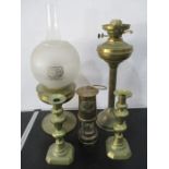 Two brass oil lamps, an E. Thomas & Williams miners lamp and a pair of brass candlesticks