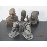 Three African wooden carved busts, a pair of bookends and an African warrior sculpture