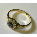 An 18ct gold sapphire and diamond cluster ring.