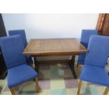 An Ercol extending dining table with four dining chairs