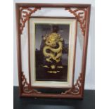 A framed three dimensional dragon believed to be made of bone in Oriental frame