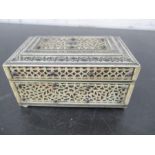 A small antique carved ivory box- damage to feet