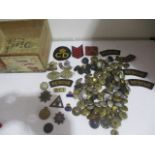 A collection of military buttons, badges, patches etc