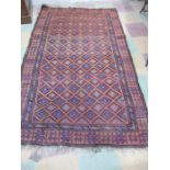 A hand woven red ground rug with geometric pattern, 203 cm x 124 cm
