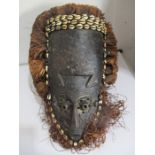 An African mask with shell decoration