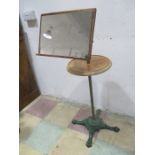 An antique adjustable shaving mirror on cast iron case