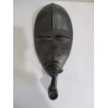 An African mask of a man smoking a pipe