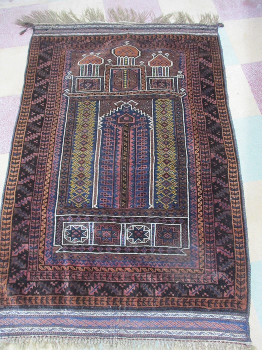 A red ground hand woven prayer rug