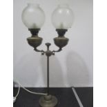 A converted double oil lamp with acid etched glass globes