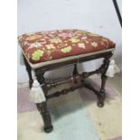 A Georgian walnut upholstered stool with turned legs