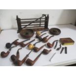 A collection of vintage smoking pipes, stand etc