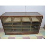 A mid century Haberdashery cabinet with 12 drawers and sliding glass doors