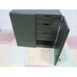 A small green painted cupboard with six drawers inside- key in office