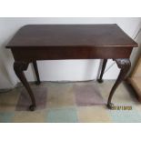 A George II mahogany side table on cabriole legs