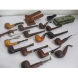 A collection of vintage smoking pipes, stands etc