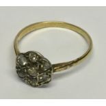 A diamond cluster ring set in gold (hallmarked rubbed)