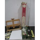 A collection of artists materials including paper, easels paints etc.