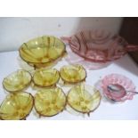 A yellow glass dessert bowl set along with one other etc