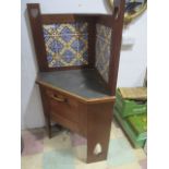 An oak Liberty & Co. corner washstand with tiled back and metal top