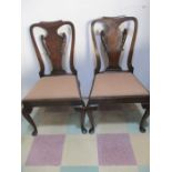 A pair of Queen Anne style dining chairs with scroll backs