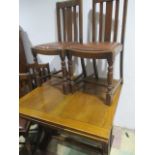 An oak draw leaf table and four chairs