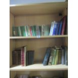 A collection of leather, children's, Romany books etc. on two shelves