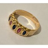 An unmarked (probably 18ct) gold ring set with blue and pink sapphires.