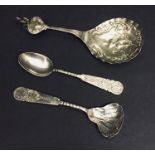 An ornate continental silver spoon along with two Chinese silver spoons.