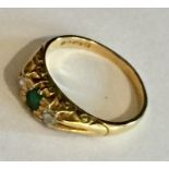 An 18ct gold ring set with emerald and diamonds.