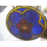 A stained glass window representing the Tudor Rose, some panels cracked, 59 cm diameter