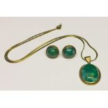 A 9ct gold pendant set with a green stone along with a pair of matching earrings.